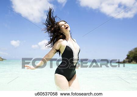 Stock Photo - USA, Virgin Islands, Saint Thomas, Beautiful woman having fun on summer vacations. Fotosearch