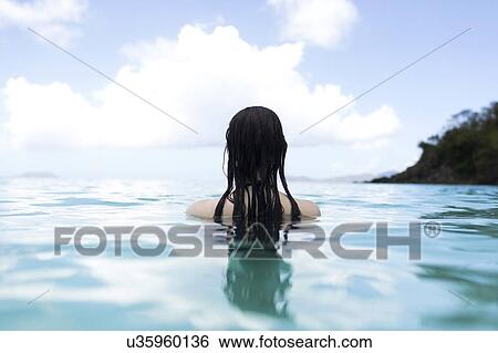 USA, Virgin Islands, Saint Thomas, Woman with long hair standing in bay View Large Photo Image Stock Photograph - USA, Virgin Islands, Saint Thomas, Woman with long hair standing in bay. Fotosearch