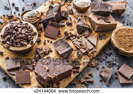 Various chocolate pieces on cutting board View Large Photo Image Picture - Various chocolate pieces on cutting board. Fotosearch
