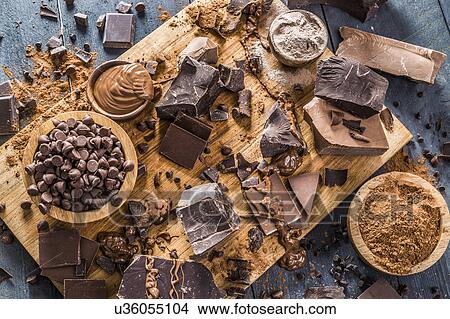 Picture - Various chocolate pieces on cutting board. Fotosearch