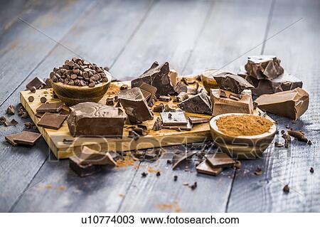 Stock Image - Various chocolate pieces on cutting board. Fotosearch