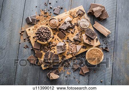 Stock Image - Various chocolate pieces on cutting board. Fotosearch