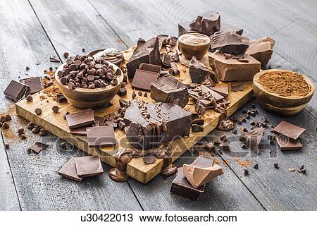 Stock Image - Various chocolate pieces on cutting board. Fotosearch