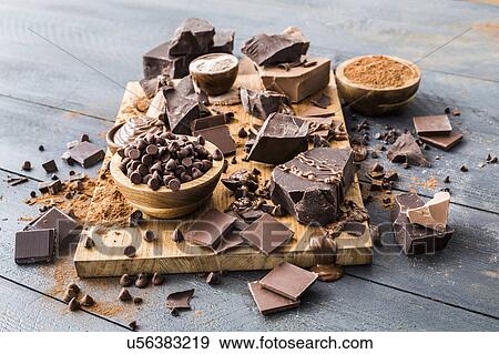 Various chocolate pieces on cutting board View Large Photo Image Stock Photo - Various chocolate pieces on cutting board. Fotosearch