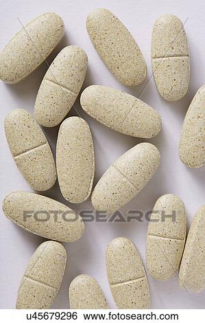 Stock Photograph - Vitamin supplements on white background. Fotosearch