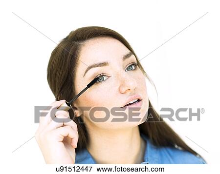 Stock Photo - Woman applying mascara. Fotosearch