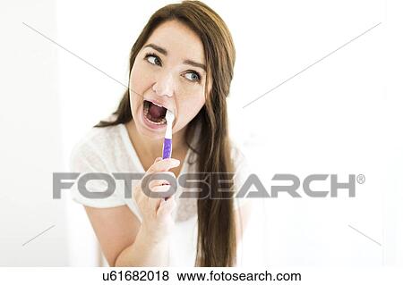 Woman brushing teeth View Large Photo Image Stock Photo - Woman brushing teeth. Fotosearch