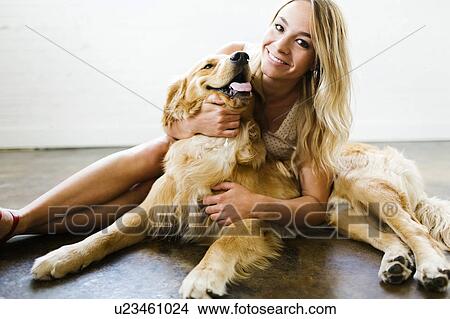 Picture - Woman cuddling dog. Fotosearch