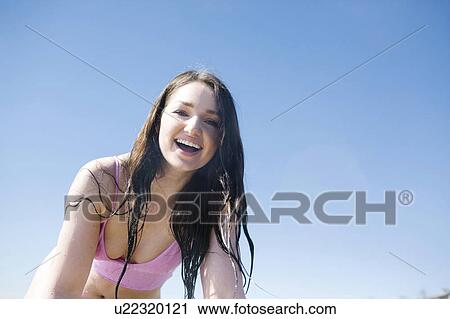 Stock Image - Woman enjoying day on beach. Fotosearch