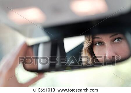 Woman face reflected in rearview mirror View Large Photo Image Stock Image - Woman face reflected in rearview mirror. Fotosearch