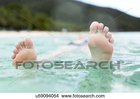 Woman floating on water View Large Photo Image Picture - Woman floating on water. Fotosearch