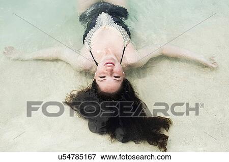 Woman floating on water View Large Photo Image Stock Photo - Woman floating on water. Fotosearch