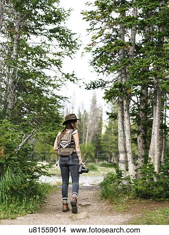 Picture - Woman hiking in forest. Fotosearch