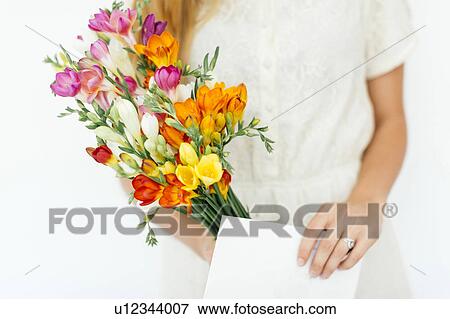Stock Photo - Woman holding bouquet and letter. Fotosearch