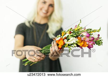 Stock Image - Woman holding bouquet. Fotosearch