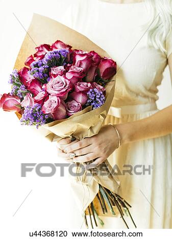 Woman holding bouquet with roses View Large Photo Image Stock Image - Woman holding bouquet with roses. Fotosearch