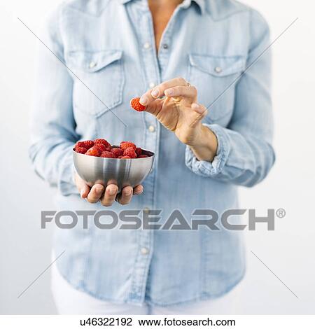Woman holding bowl of raspberries View Large Photo Image Stock Image - Woman holding bowl of raspberries. Fotosearch