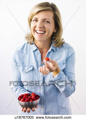 Woman holding bowl of raspberries View Large Photo Image Stock Photography - Woman holding bowl of raspberries. Fotosearch