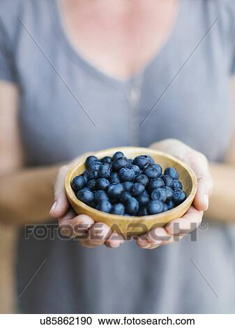 Woman holding bowl with blueberries View Large Photo Image Stock Image - Woman holding bowl with blueberries. Fotosearch