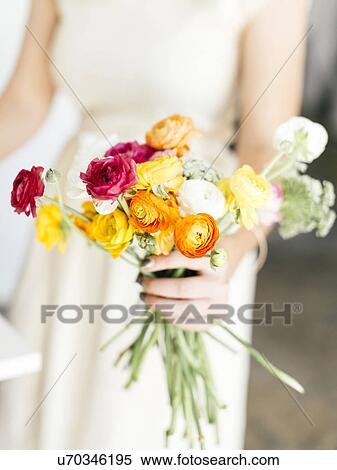 Woman holding bunch of flowers View Large Photo Image Stock Photography - Woman holding bunch of flowers. Fotosearch