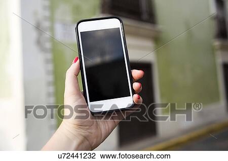 Woman holding phone View Large Photo Image Stock Image - Woman holding phone. Fotosearch