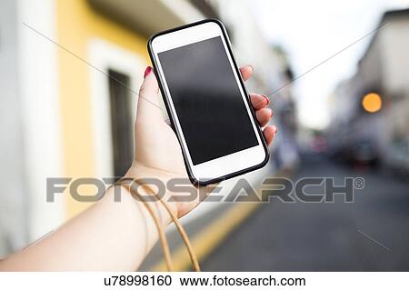 Stock Image - Woman holding phone. Fotosearch
