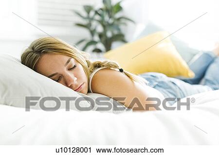 Stock Image - Woman in bed sleeping. Fotosearch