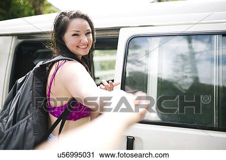 Woman in bikini standing by car and holding somebody' s hand View Large Photo Image Stock Image - Woman in bikini standing by car and holding somebody' s hand. Fotosearch