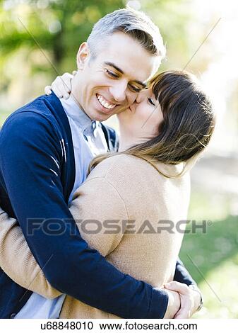 Stock Image - Woman kissing man. Fotosearch