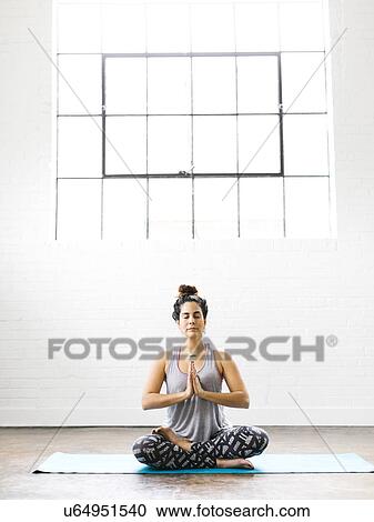 Woman meditating on exercise mat View Large Photo Image Stock Image - Woman meditating on exercise mat. Fotosearch