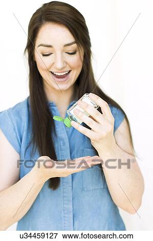 Stock Photo - Woman pouring hand sanitizer. Fotosearch