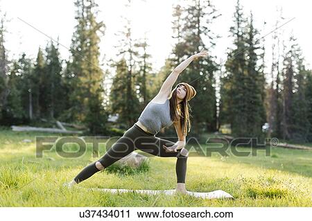 Woman practicing yoga in forest View Large Photo Image Stock Image - Woman practicing yoga in forest. Fotosearch