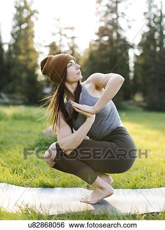 Woman practicing yoga in forest View Large Photo Image Stock Photograph - Woman practicing yoga in forest. Fotosearch