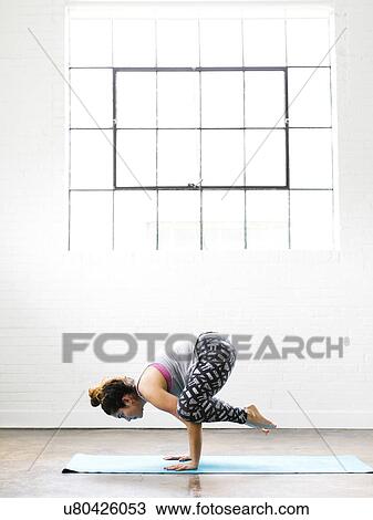 Woman practicing yoga on exercise mat View Large Photo Image Stock Image - Woman practicing yoga on exercise mat. Fotosearch