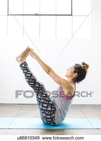 Woman practicing yoga on exercise mat View Large Photo Image Stock Photo - Woman practicing yoga on exercise mat. Fotosearch