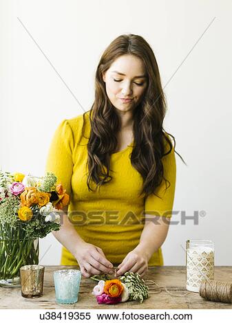 Stock Photography - Woman preparing bouquet of flowers. Fotosearch