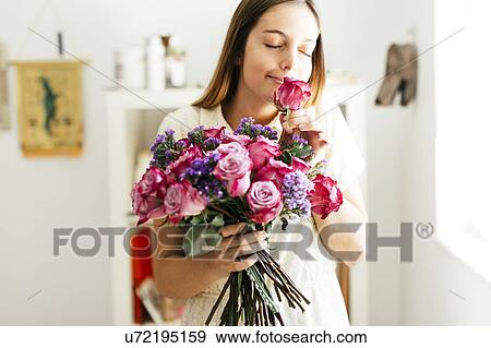 Woman smelling bouquet of roses View Large Photo Image Stock Photo - Woman smelling bouquet of roses. Fotosearch