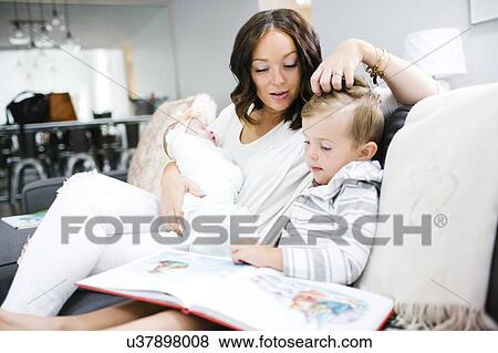 Stock Photo - Woman spending time with children (0-1 months, 4-5). Fotosearch