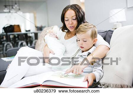 Woman spending time with children (0-1 months, 4-5) View Large Photo Image Stock Photo - Woman spending time with children (0-1 months, 4-5). Fotosearch