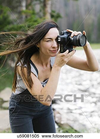 Woman taking pictures by lake View Large Photo Image Stock Photography - Woman taking pictures by lake. Fotosearch