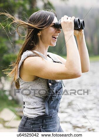 Woman using binoculars View Large Photo Image Stock Image - Woman using binoculars. Fotosearch