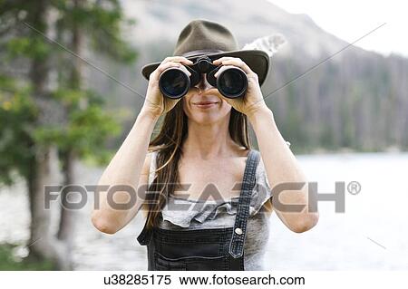Stock Photography - Woman using binoculars. Fotosearch