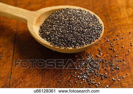 Wooden spoon full of chia seeds on table View Large Photo Image Stock Image - Wooden spoon full of chia seeds on table. Fotosearch