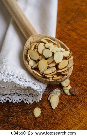 Wooden spoon full of sliced almond on table View Large Photo Image Stock Photography - Wooden spoon full of sliced almond on table. Fotosearch