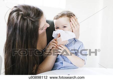 Young boy (4-5) blowing nose View Large Photo Image Stock Image - Young boy (4-5) blowing nose. Fotosearch