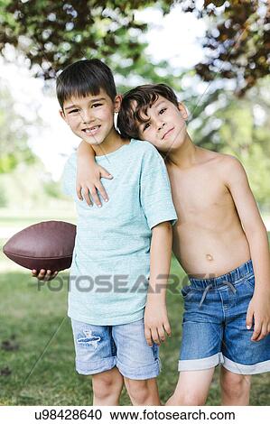 Young boys (6-7, 8-9) with american football ball View Large Photo Image Stock Image - Young boys (6-7, 8-9) with american football ball. Fotosearch