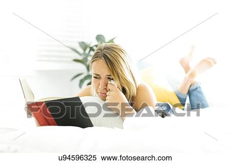 Young woman reading book and crying View Large Photo Image Stock Photography - Young woman reading book and crying. Fotosearch