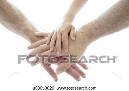Stock Photo - Adults and child's hands on top of each other.. Fotosearch