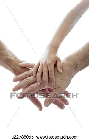 Stock Photography - Adults and child's hands on top of each other.. Fotosearch