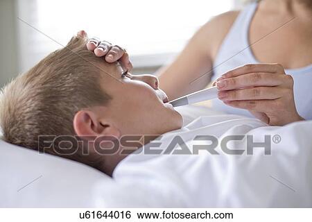 Boy having his temperature taken. View Large Photo Image Stock Photograph - Boy having his temperature taken.. Fotosearch